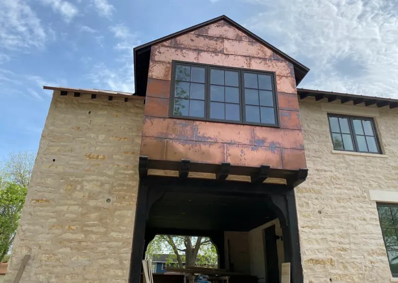 Copper metal panel facade on a stone building for Skylight Installation in Chula Vista